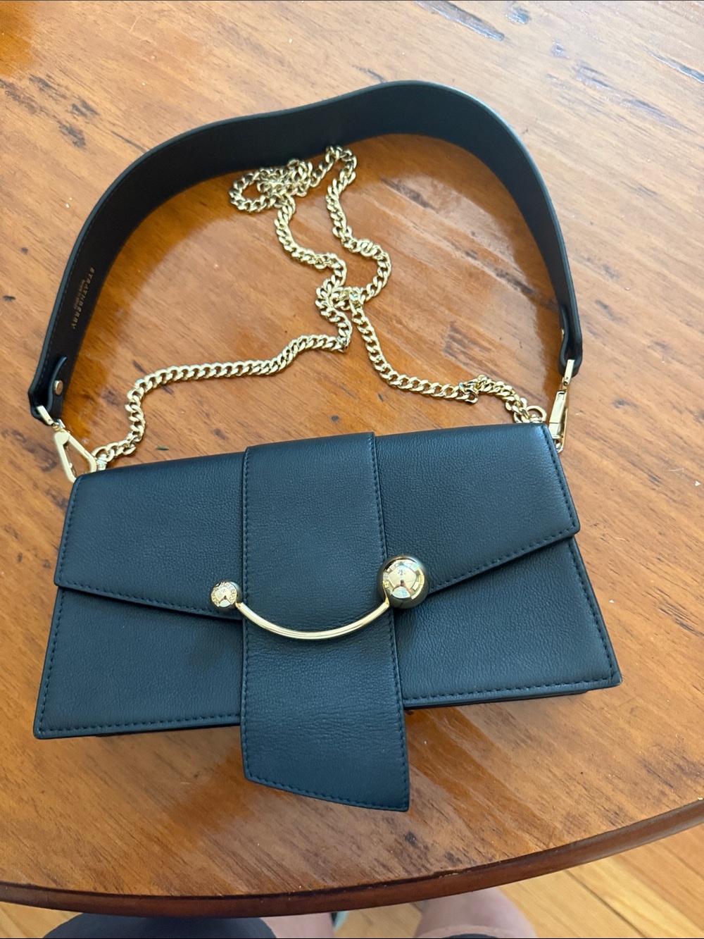 Strathberry Mini Crescent Black Leather Shoulder Bag with Gold Hardware.